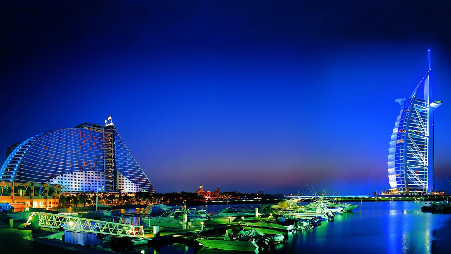 Night panorama of UAE skyline with illuminated cultural landmarks
